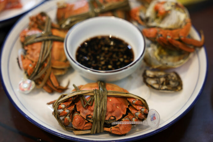 Steamed hairy crabs sit on a plate in Suzhou