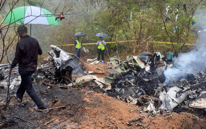 Security officials secure the wreckage of the aircraft 5Y-CCA operated by Mombasa Air Services, which crashed in Kwale County