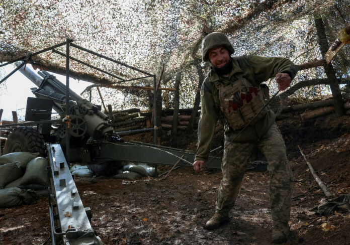Ukrainian serviceman fires howitzer towards Russian troops near the frontline town of Pokrovsk